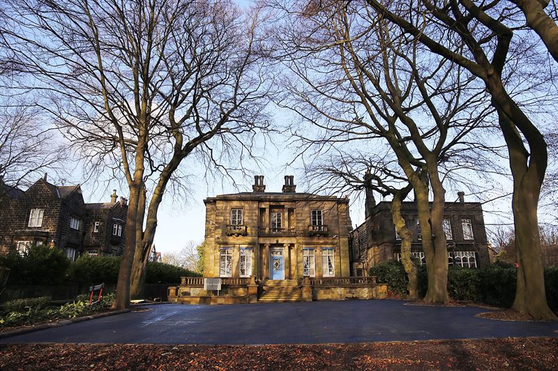 Clean completed asphalt surface at a substantial property entrance
