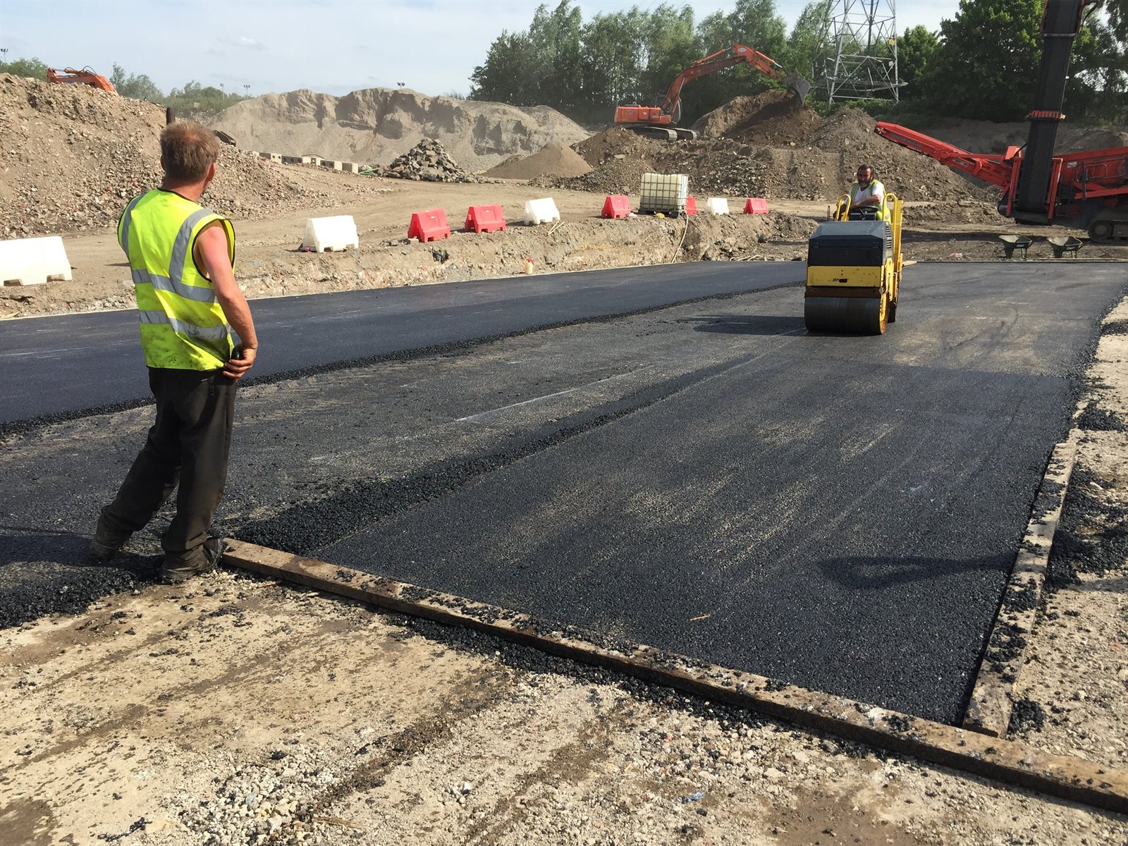 Atkinson Surfacing roller compacting newly laid asphalt