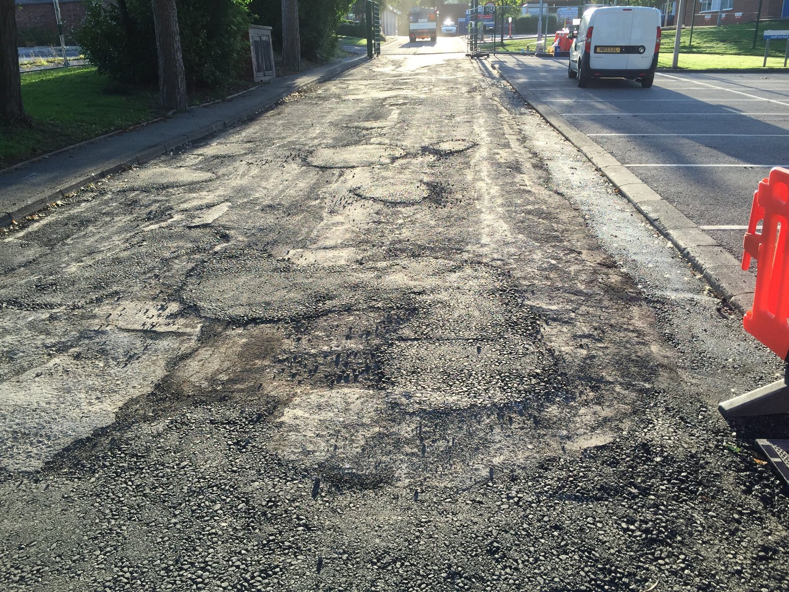 Worn asphalt with previous patching before repair