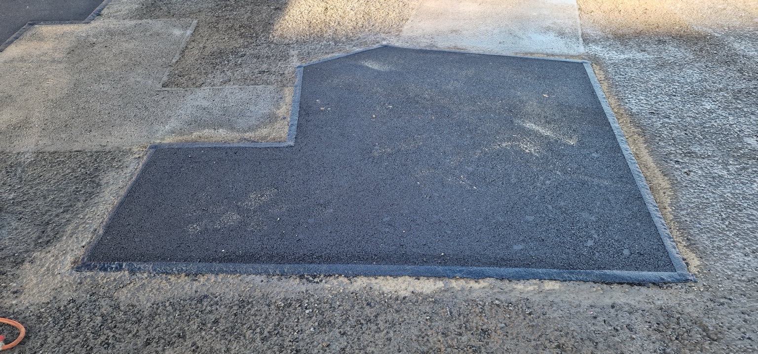 Completed asphalt patch repair in a Harrogate car park