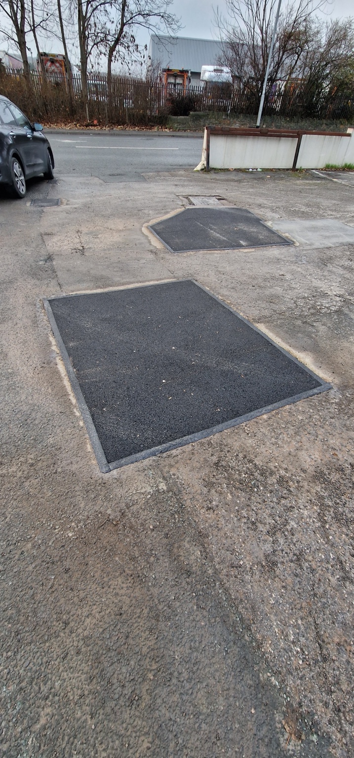 Multiple completed asphalt patches at the Harrogate car park entrance