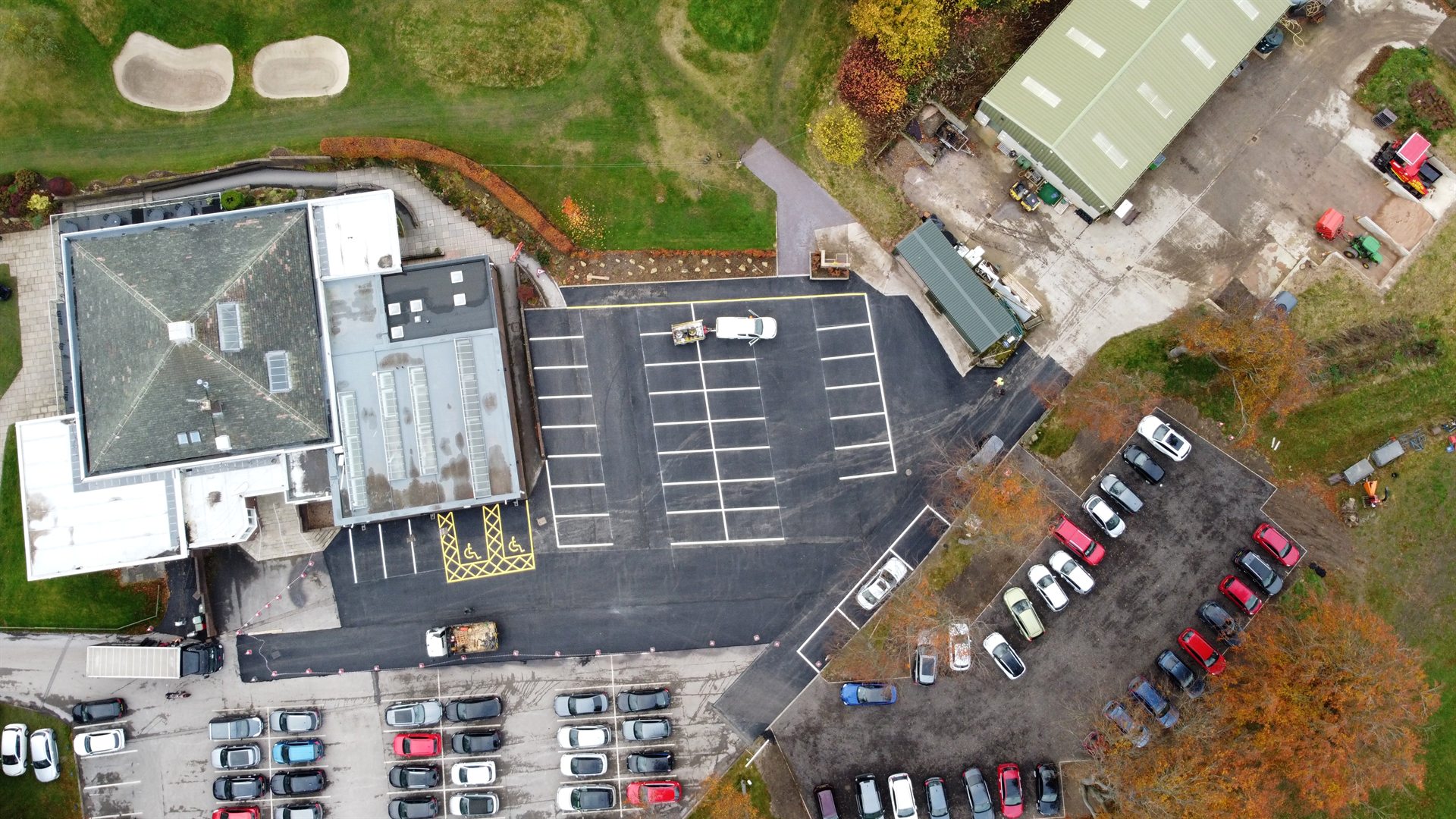 Top-down drone view of completed asphalt and white line marking